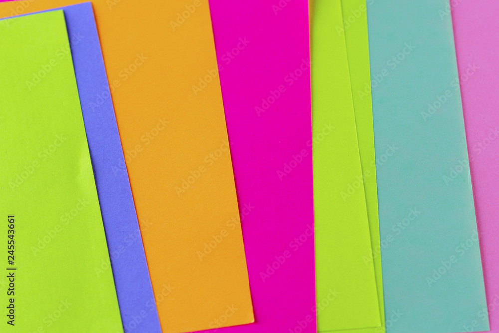 Blue,pink,yellow,purple,green,orange neon paper color for background. Striped geometric pattern of bright colors.