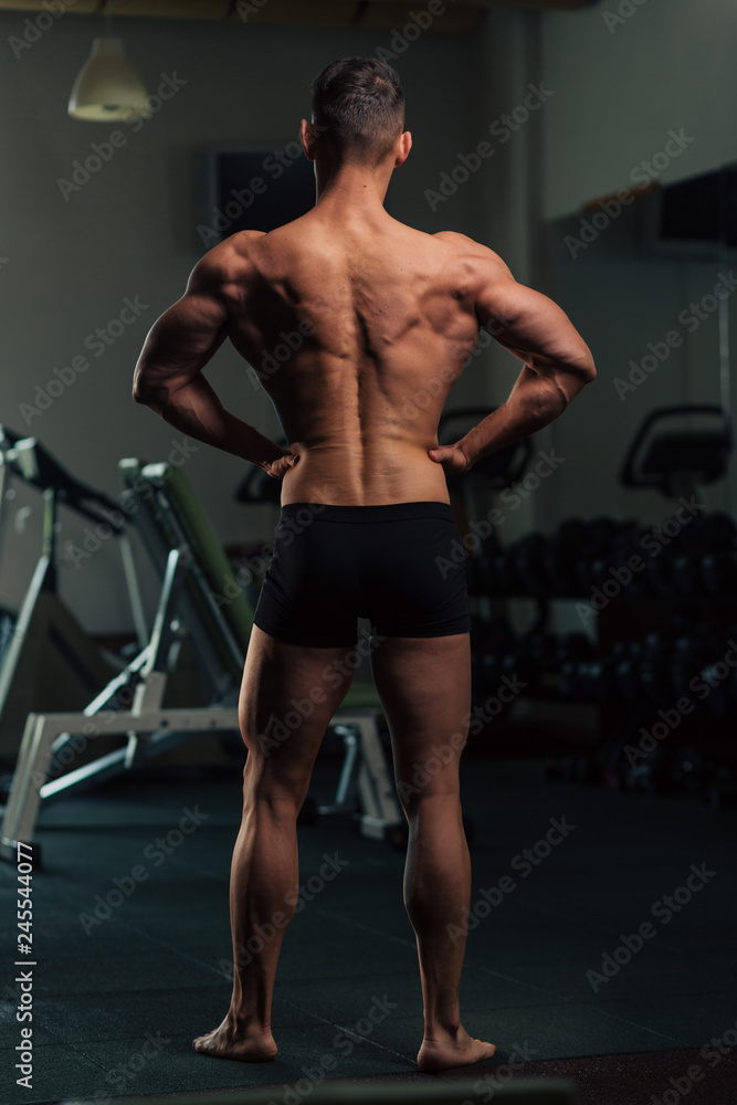 Young fit man doing bodybuilding competition poses Young fit man doing bodybuilding competition poses