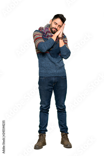 Full-length shot of Hippie man making sleep gesture in dorable expression on isolated white background