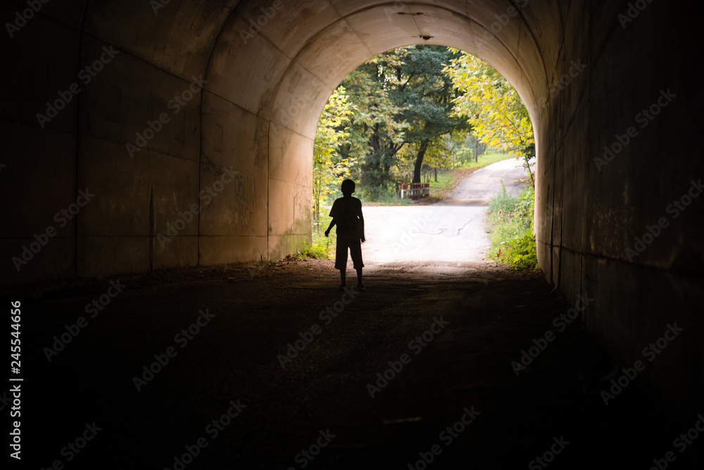 boy in an underground tunnel