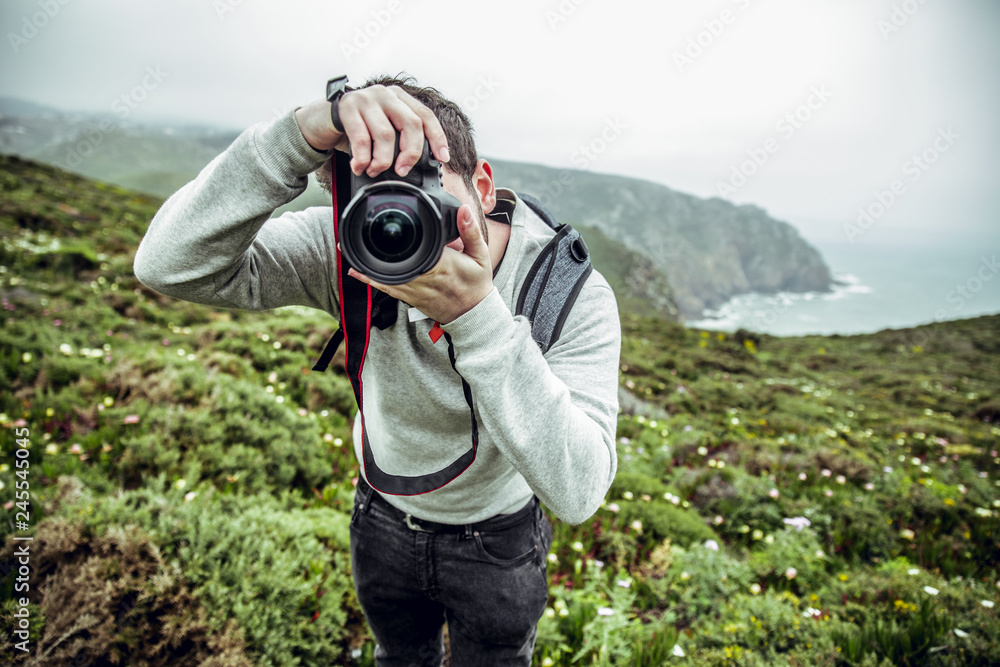 Photographer taking photo at Cabo da Roca Cliffs, Portugal