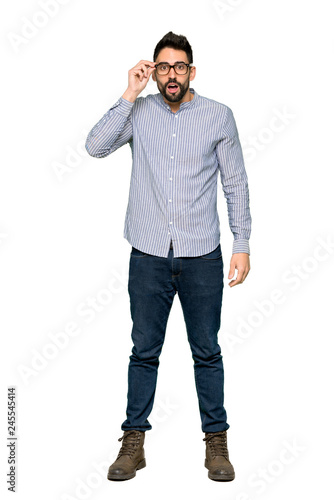 Full-length shot of Elegant man with shirt with glasses and surprised on isolated white background