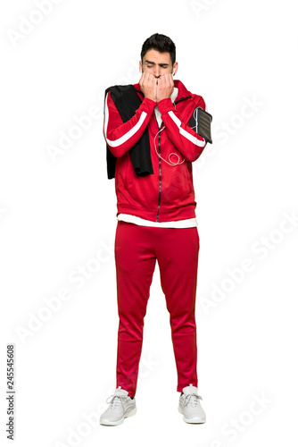 Full-length shot of Handsome sportman is a little bit nervous and scared putting hands to mouth on isolated white background