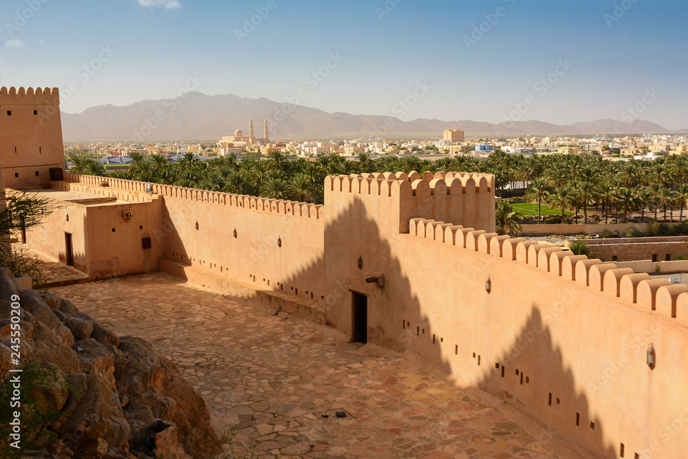 Φωτογραφία Walls of the Fort of Nahkal and the village with the mosque in the background (O