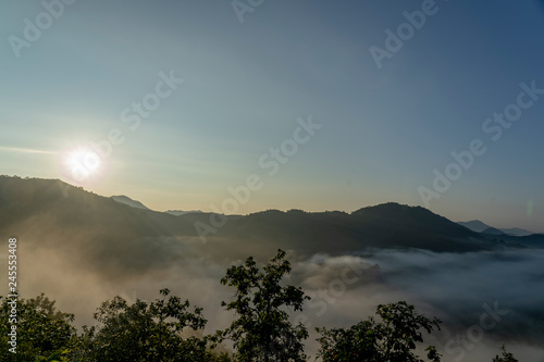 In the morning, the sun, the high mountains, the fog and the beautiful sky.