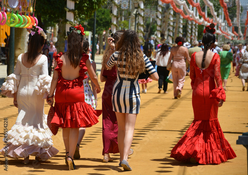 the girls at the festival with the typical flamenco dresses