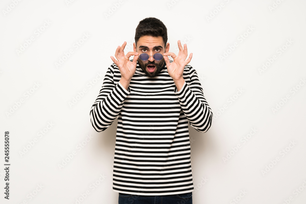 handsome man with striped shirt with glasses and surprised handsome man with striped shirt with glasses and surprised