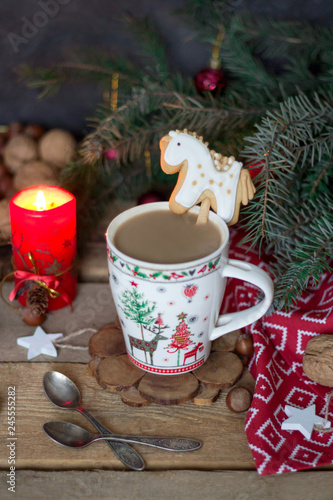 Christmas composition with a mug of coffee, gingerbread, fir branches and Christmas decorations.