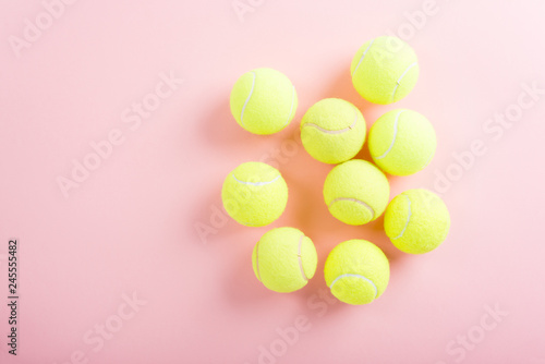 Tennis balls over pink background  top view
