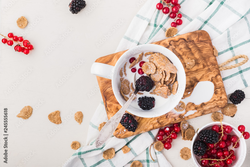 Breakfast bowl with cereal, berries and milk, top view Breakfast bowl with cereal, berries and milk, top view