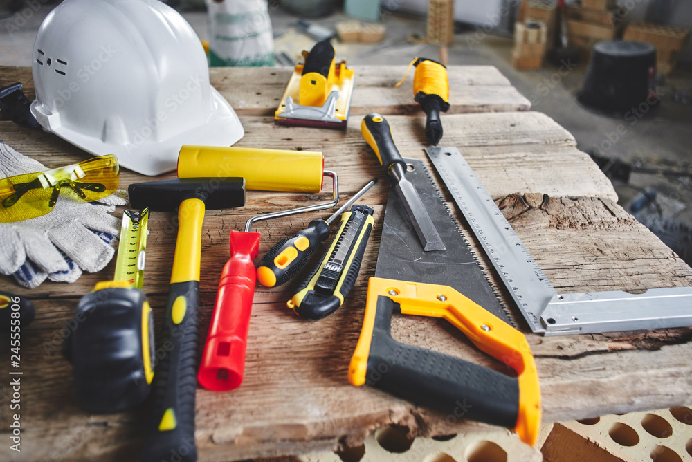 Fototapeta premium Home repairs. Construction tools, bricks and helmet