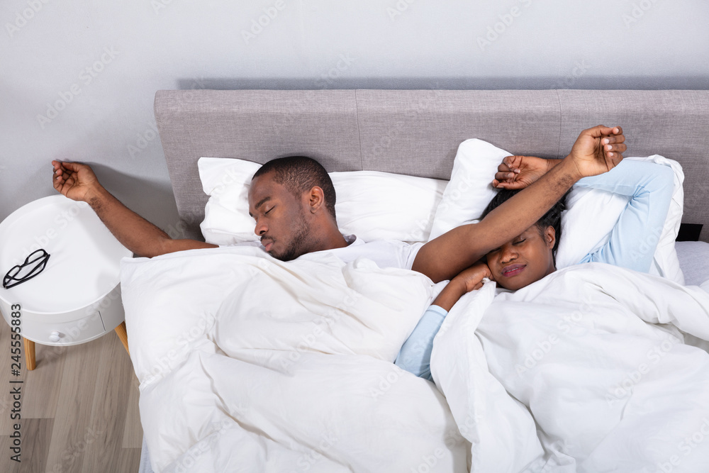 Fototapeta premium Married Couple Napping On Bed