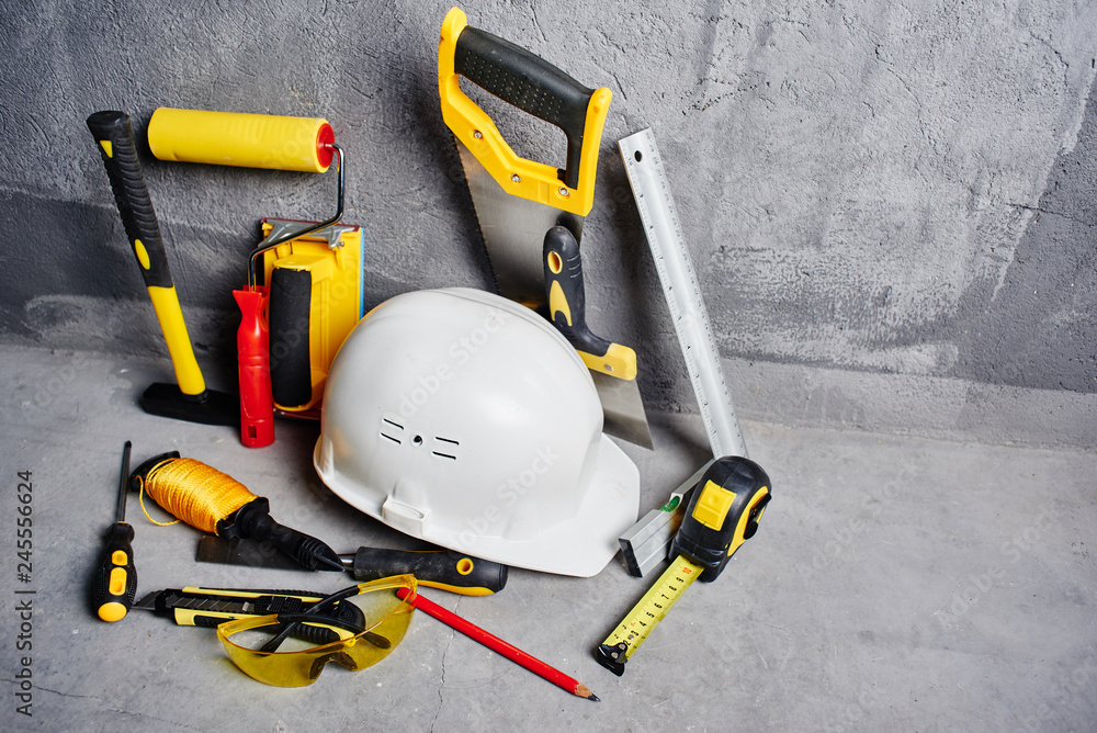 set of construction tools on a black wall background