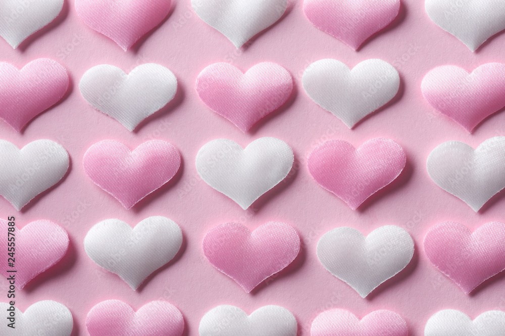 Pink and white textile hearts on pink background. Valentines day texture and love concept