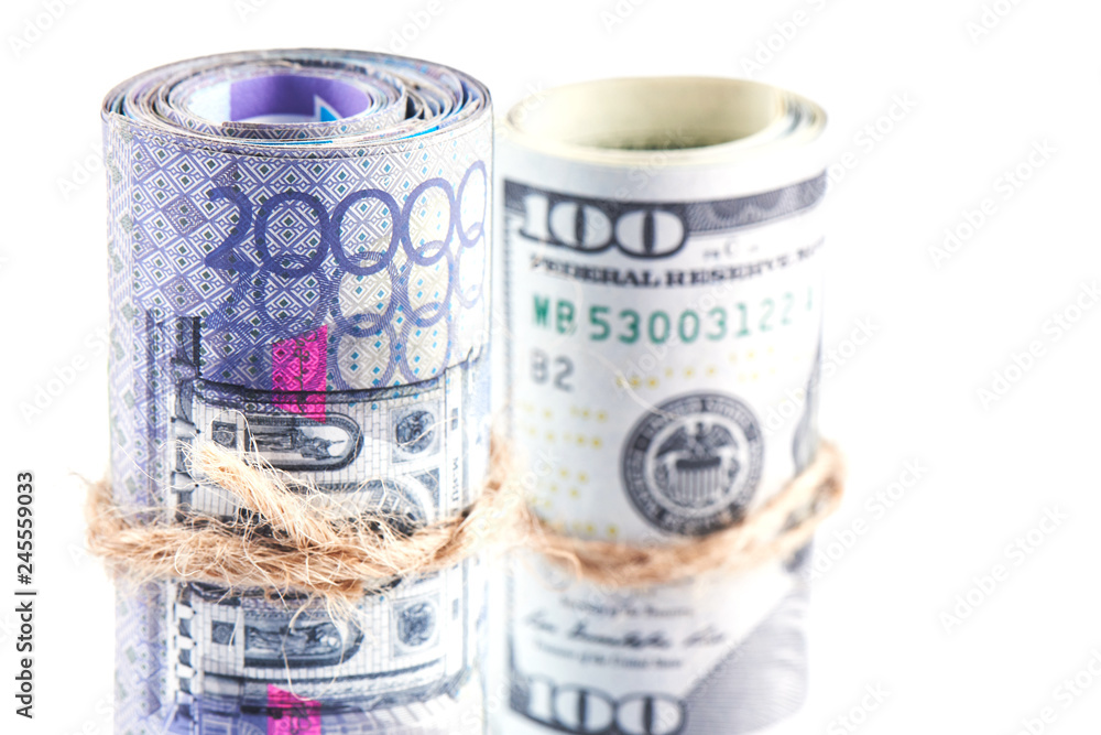 Dollars and tenge. American and Kazakh money on a white background. Isolated. Dollars and tenge. American and Kazakh money on a white background. Isolated.
