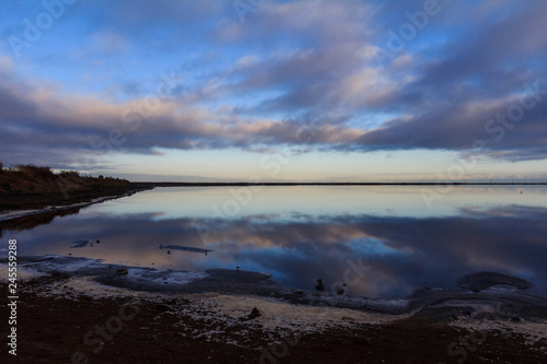 Fototapeta Naklejka Na Ścianę i Meble -  Reflection of a Blue Sunrise in the Water at Alviso Marina County Park