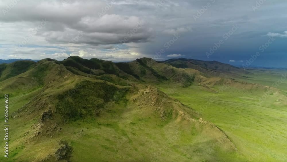 Aerial shoot of natural mongolian grasslands surrounded by mountains in the North Mongolia. Aerial shoot of natural mongolian grasslands surrounded by mountains in the North Mongolia.