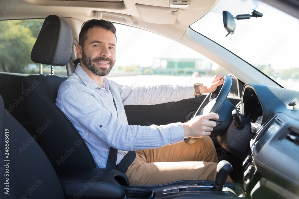 Portrait Of Smiling Man Driving New Car In City Portrait Of Smiling Man Driving New Car In City