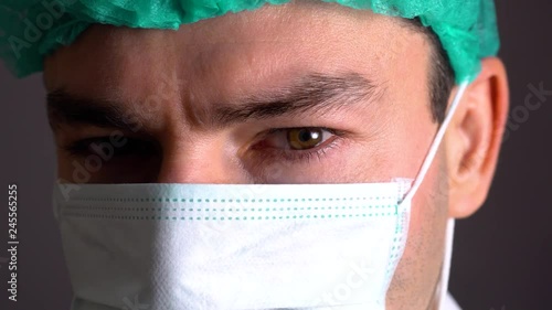 close up portrait of a surgeon or doctor with mask and headset ready for operation in hospital or clinic photo