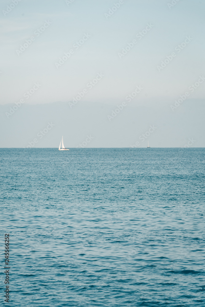 Sailboat in the Mediterranean, from La Barceloneta, in Barcelona, Spain Sailboat in the Mediterranean, from La Barceloneta, in Barcelona, Spain