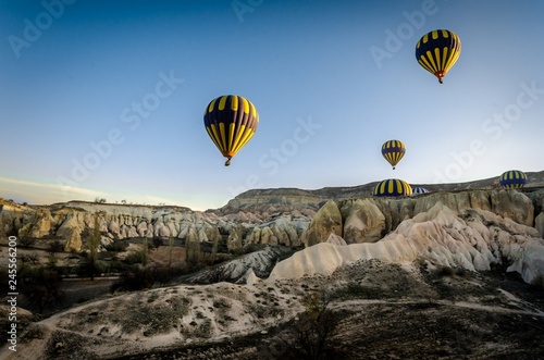 Hot air balloon flying overv olcanic rock landscape, Cappadocia,