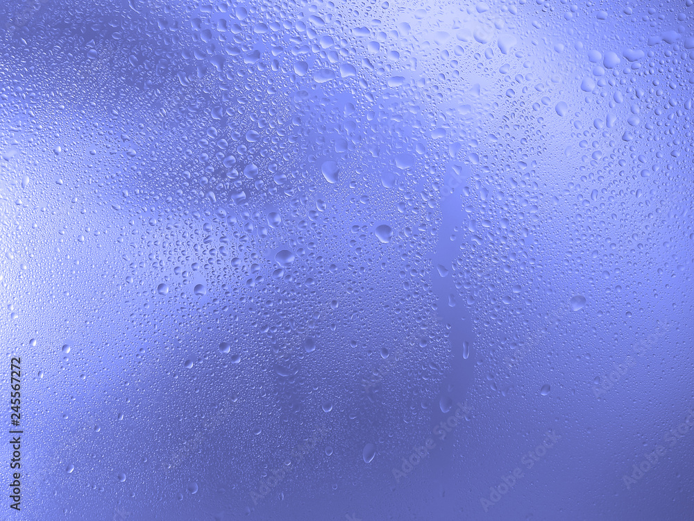 Drops of water on the glass, blue color. Image for background or wallpaper.