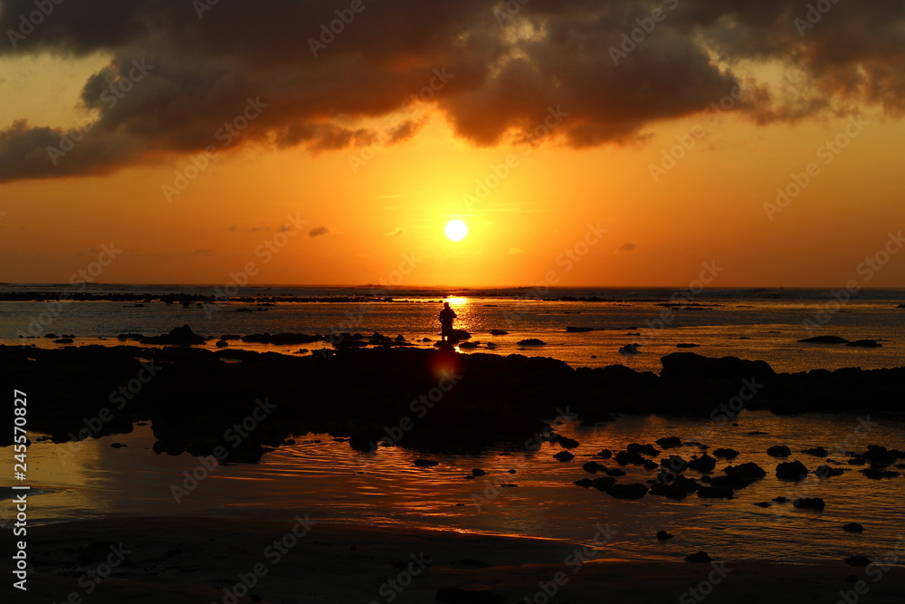 Silouette of a man in the beachside at the sunset