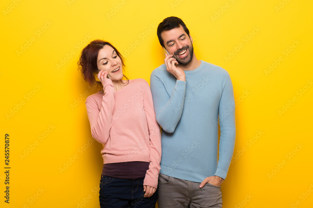 Couple in valentine day keeping a conversation with the mobile phone Couple in valentine day keeping a conversation with the mobile phone
