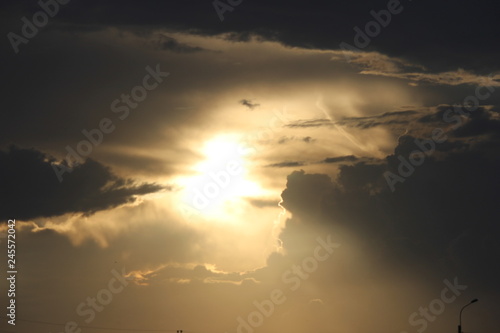 the sun behind the cloud
