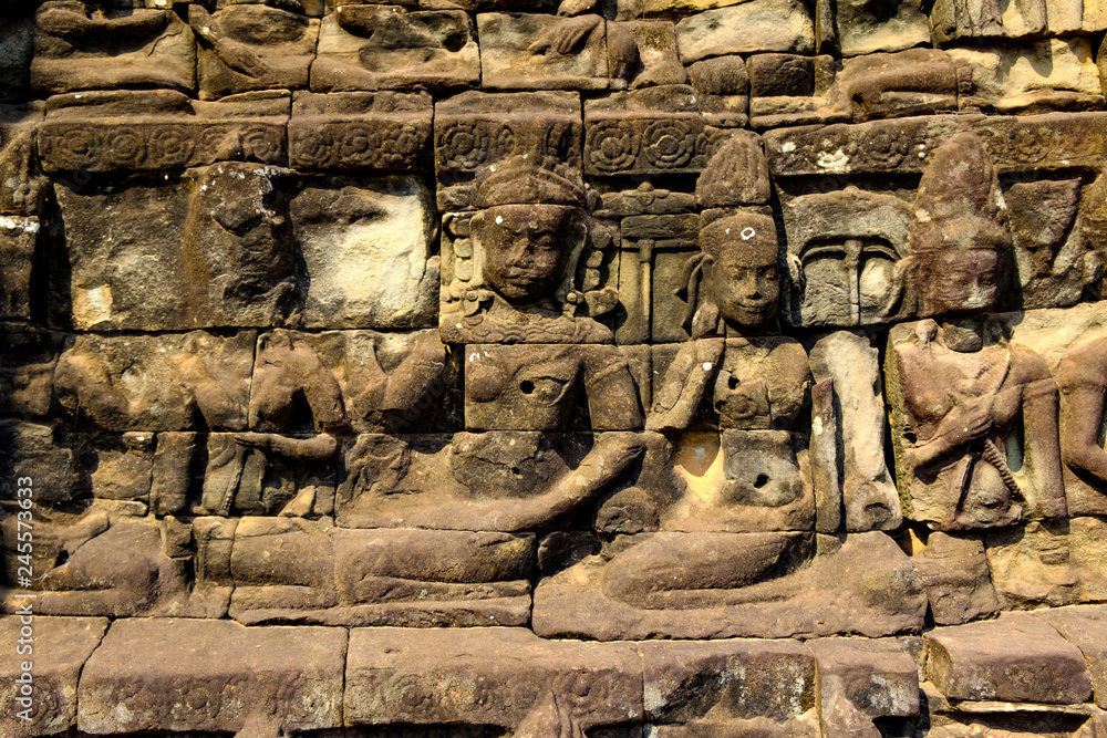 Reliefs on surface of the wall of old ancient temple. Abstract background. Reliefs on surface of the wall of old ancient temple. Abstract background.