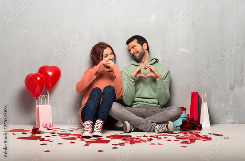 Couple in valentine day making heart symbol by hands