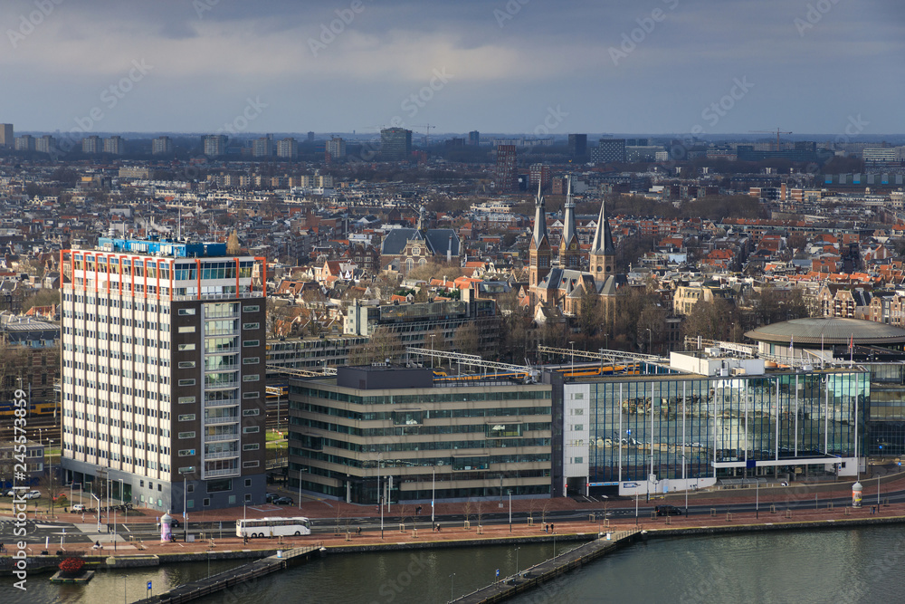 Aerial: Modern buildings on the riverbank of Amsterdam