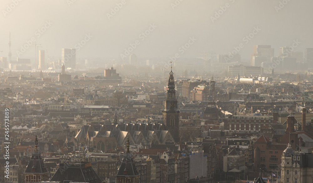 Aerial: Misty cityscape of Amsterdam