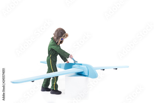 Young boy repairing airplane