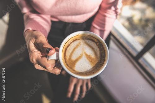 woman's hand holding coffee bird eye view