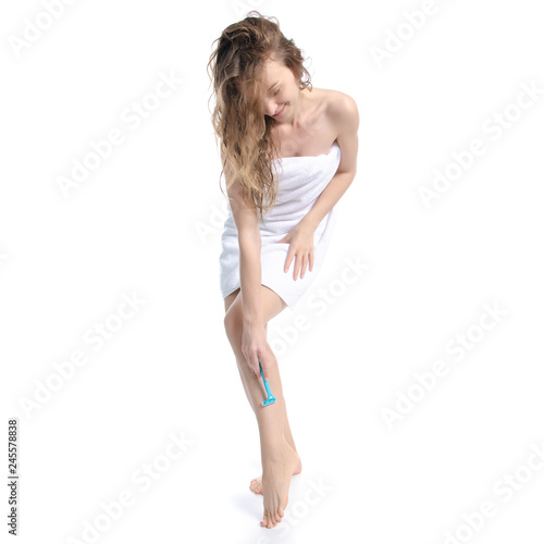 Beautiful woman in white towel razor in hand beauty on white background isolation © Kabardins photo