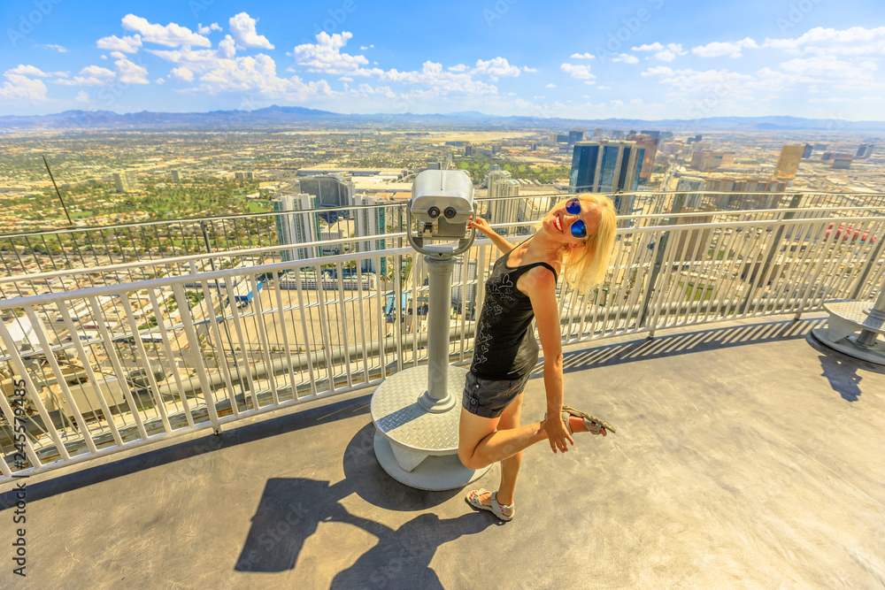 Woman enjoying at binocular from tower observation deck in Las Vegas