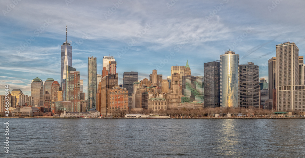 Manhattan skyline and Hudson river daylight view with clouds in sky