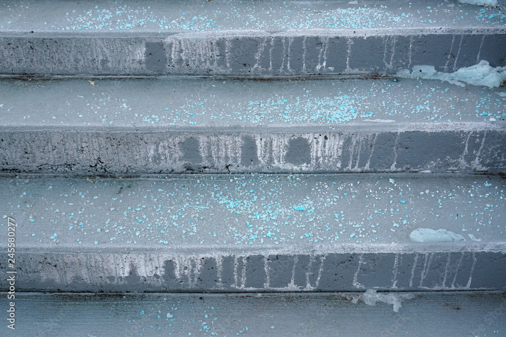 Melting salt on the stair steps in winter season