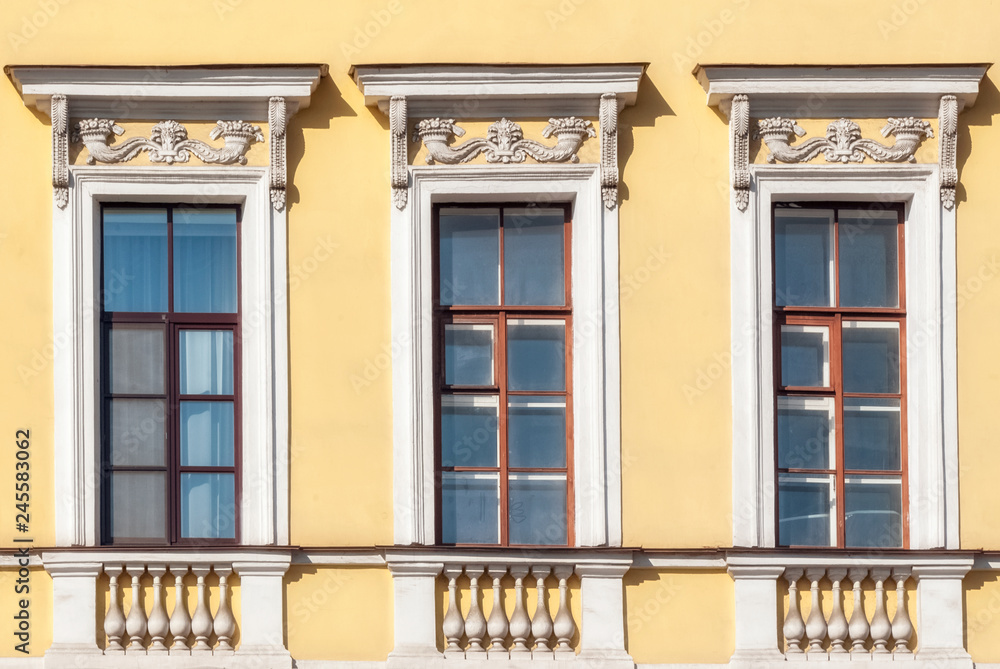 Windows on the yellow wall.
