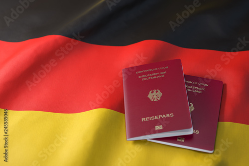 Passport of Germany on the flag of the Germany. Getting a Germnay passport,  naturalization and immigration concept. photo