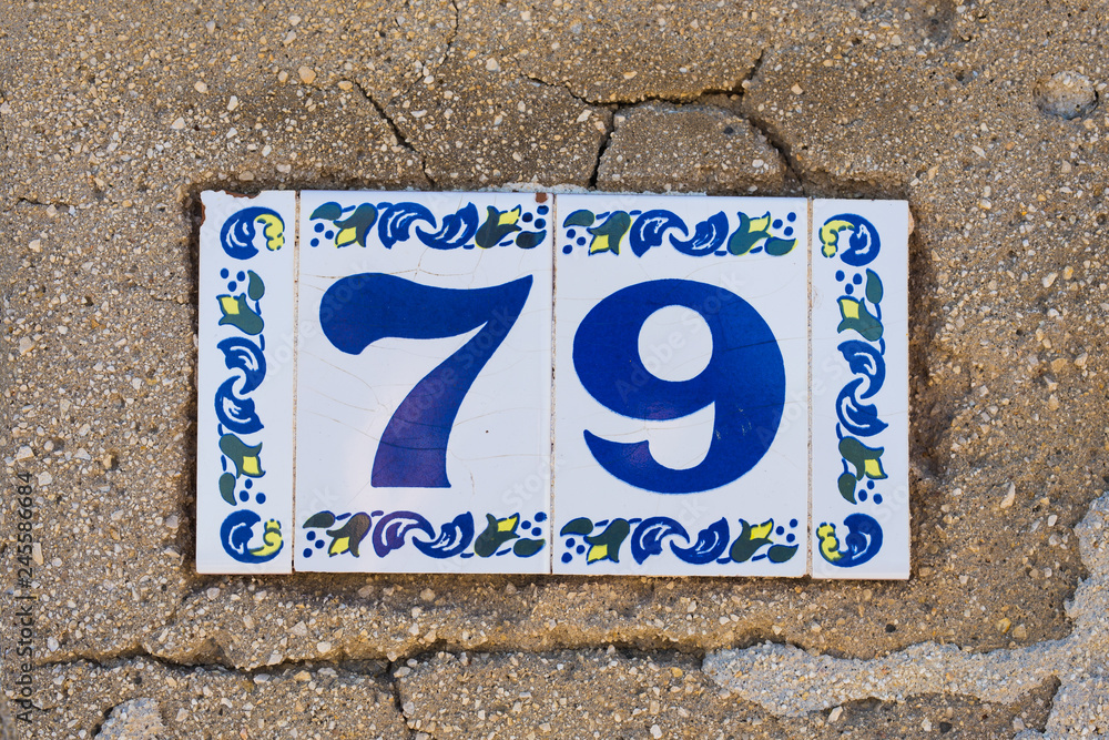 Fototapeta premium House number seventy nine 79 close up, ceramic plate