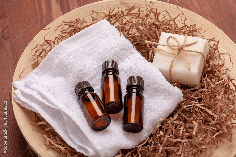 Essential oils in small brown glass bottles on wooden background Essential oils in small brown glass bottles on wooden background