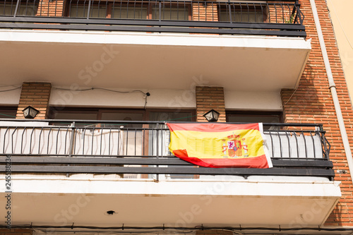 Flag of Spain hanging on the balcony of a house