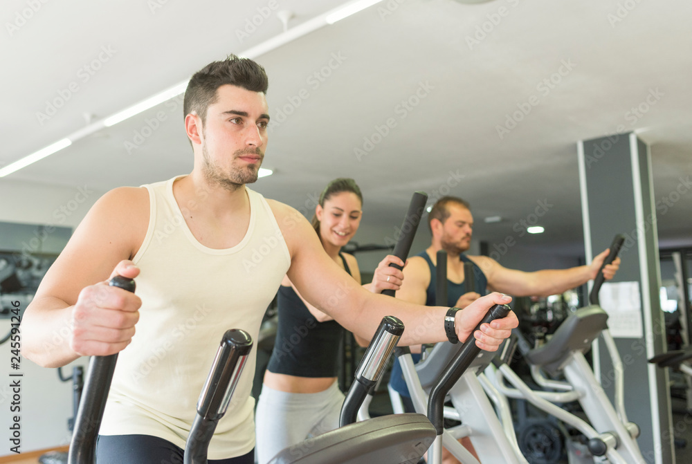 Fototapeta premium People training at cross trainer elliptical bike