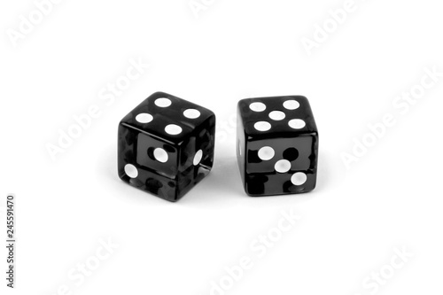 Two black glass dice isolated on white background. Four and five.