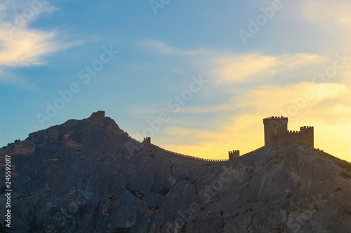 Genoese fortress in Sudak on the background of the evening sky, Crimea. Beautiful evening landscape.