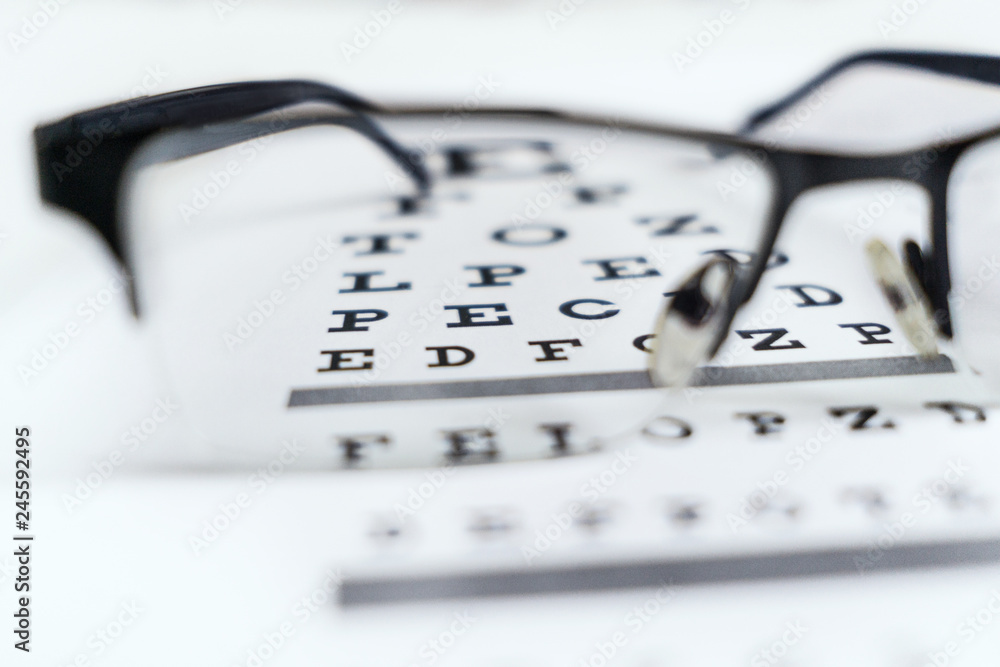 Glasses in the hands on the background of the table for vision Glasses in the hands on the background of the table for vision