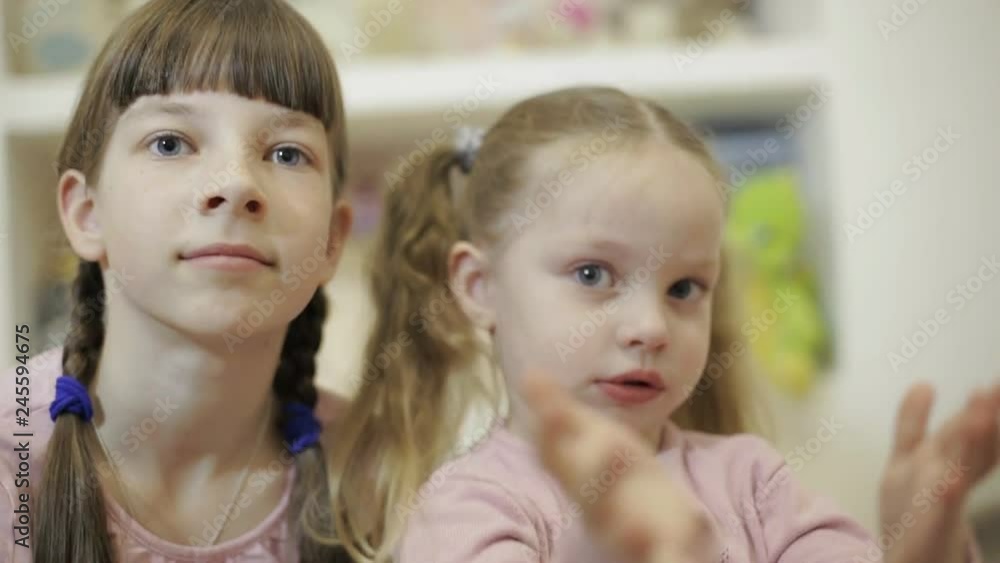 two little girls having video chat using smartphone with their friends two little girls having video chat using smartphone with their friends