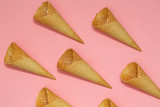 Ice cream waffle cones on pastel pink background, top view flat lay, minimal composition. Place for text